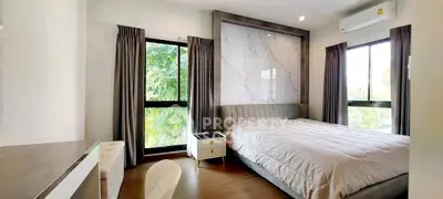 Modern bedroom with large windows and stylish decor