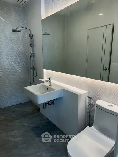 Modern bathroom with elegant fixtures and textured wall design
