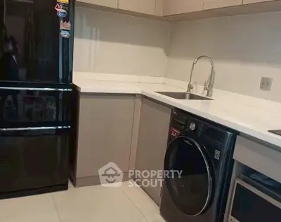 Modern kitchen with sleek appliances and corner sink