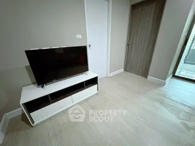 Modern living room with sleek TV stand and wooden flooring