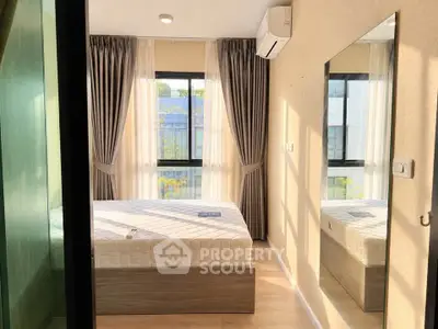 Bright and cozy bedroom with large window and modern decor