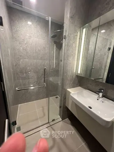 Modern bathroom with glass shower and sleek sink design