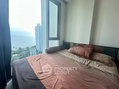 Cozy bedroom with stunning ocean view in high-rise apartment