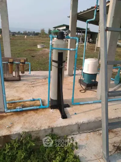 Outdoor water filtration system on a concrete platform in a rural setting
