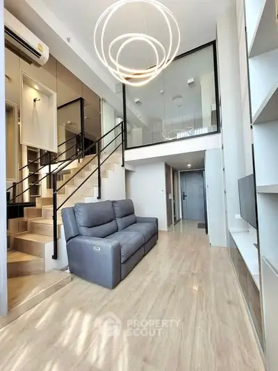 Modern duplex living room with stylish lighting and sleek staircase