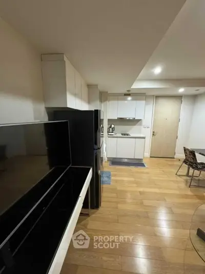 Modern apartment interior with open kitchen and wooden flooring