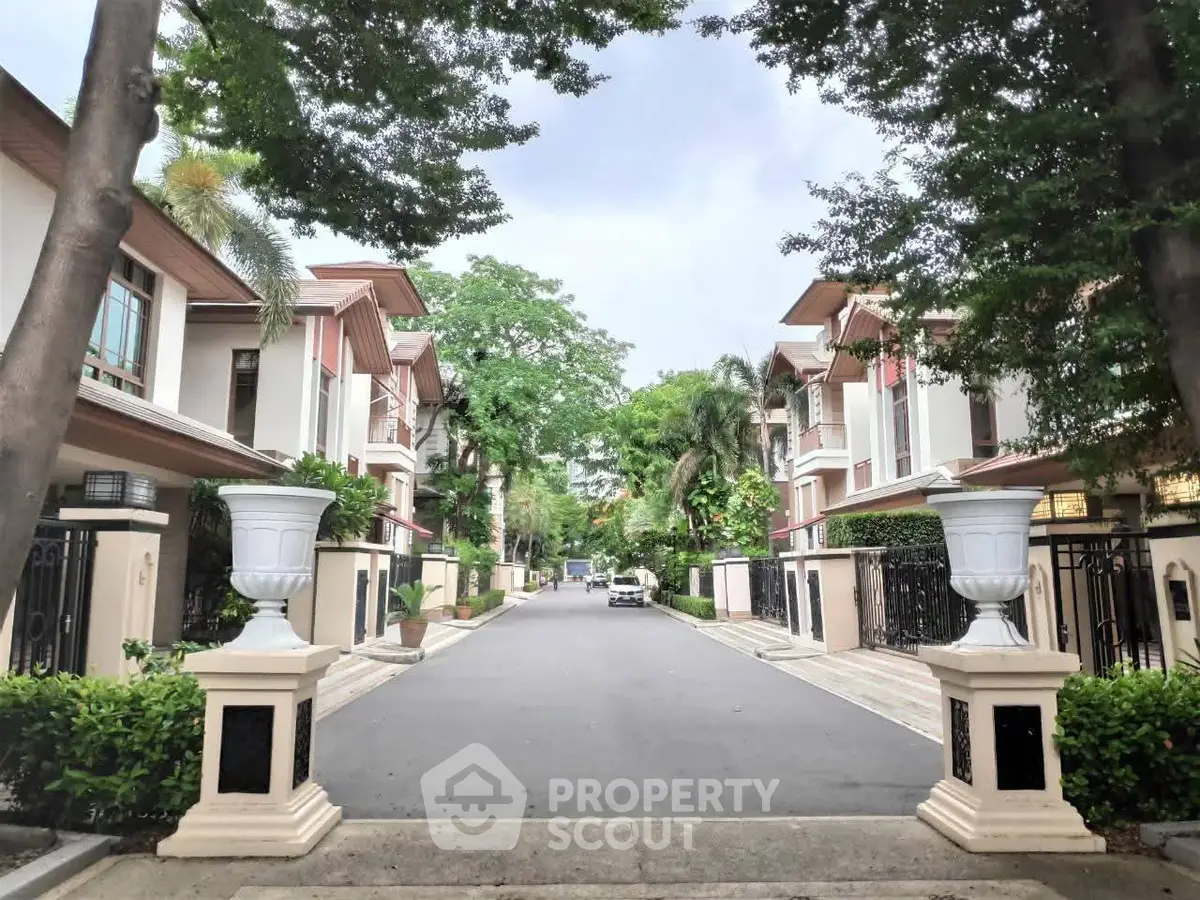 Elegant residential street with modern townhouses and lush greenery