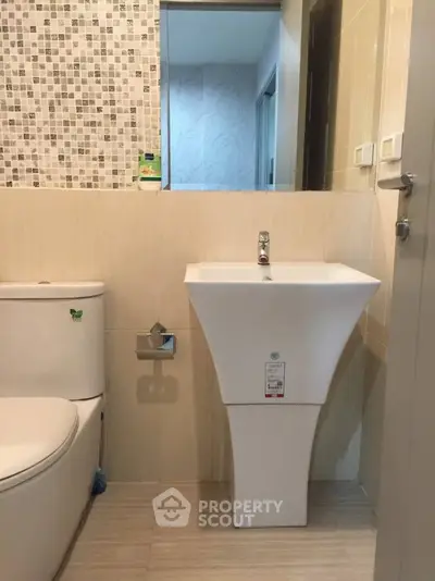 Modern bathroom with stylish sink and tiled wall design