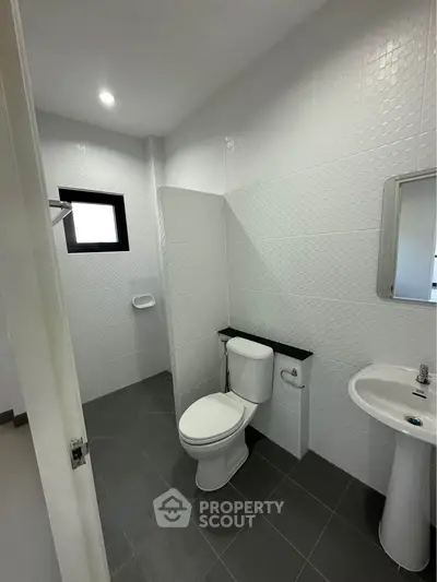 Modern bathroom with sleek white tiles and minimalist fixtures