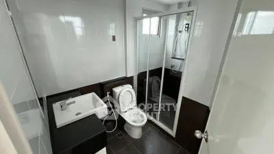 Modern bathroom with sleek fixtures and glass shower enclosure