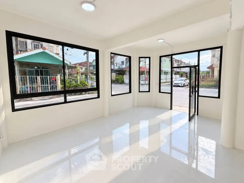 Bright corner unit with large windows and tiled flooring, offering a spacious and inviting atmosphere.