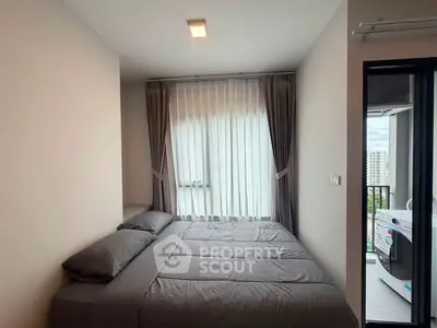 Cozy bedroom with modern decor and balcony access in a stylish apartment.