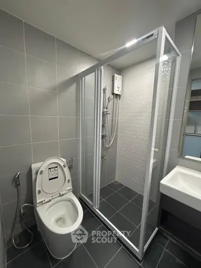 Modern bathroom with glass shower enclosure and sleek fixtures