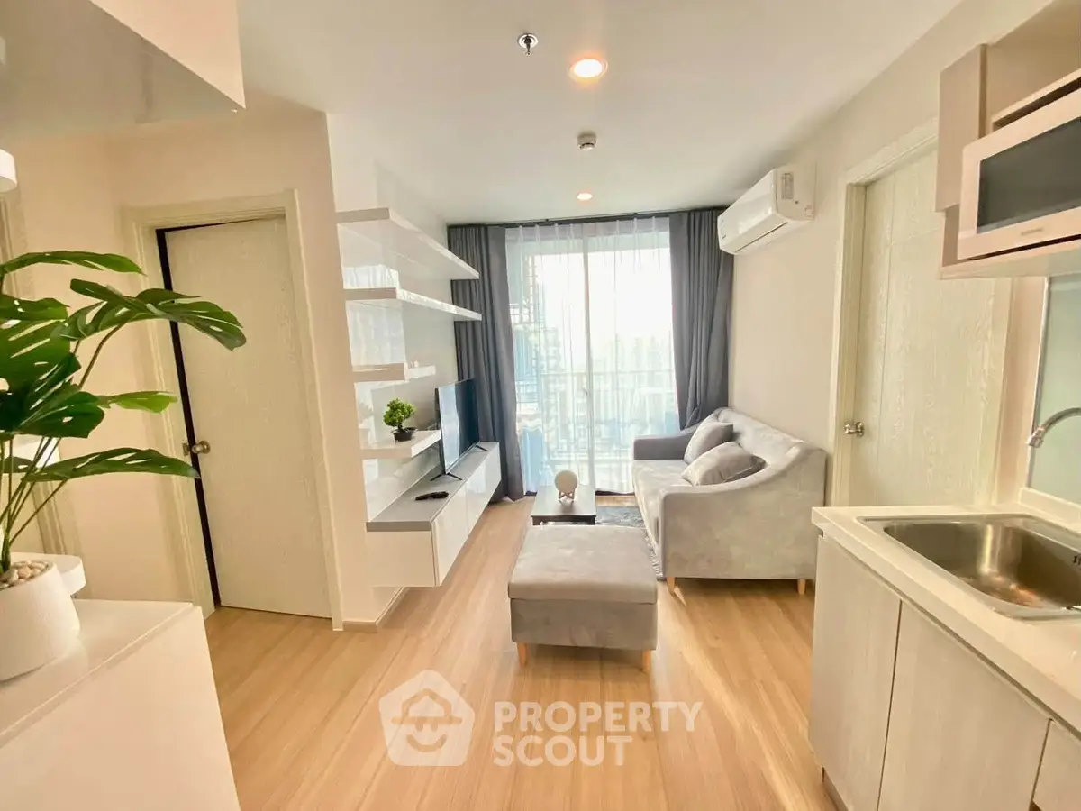 Modern living room with sleek design and natural light, featuring cozy seating and stylish decor.