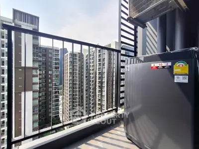 Modern balcony with city view and compact refrigerator, perfect for urban living.