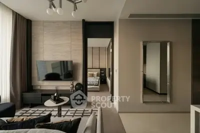 Modern living room with sleek design and stylish decor, featuring a wall-mounted TV and cozy seating area.
