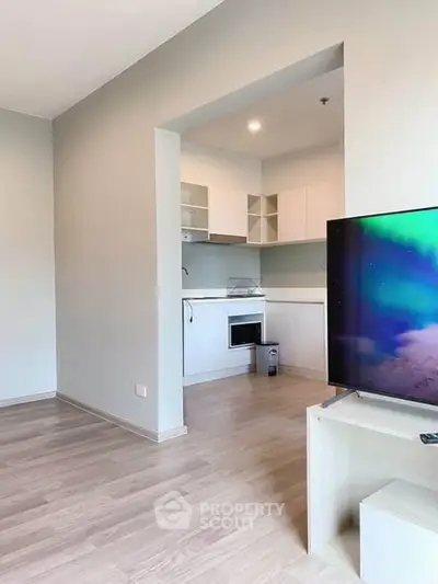 Modern open-plan living room with sleek kitchen and stylish flooring