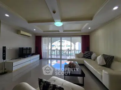 Spacious living room with modern furniture and large balcony view