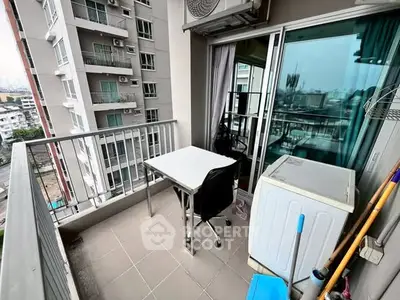 Modern balcony with city view, featuring a table and chair, perfect for relaxation.