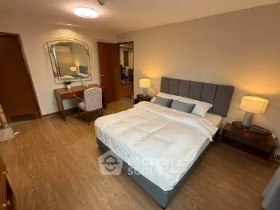 Spacious bedroom with elegant decor and cozy ambiance, featuring a comfortable bed and stylish furniture.