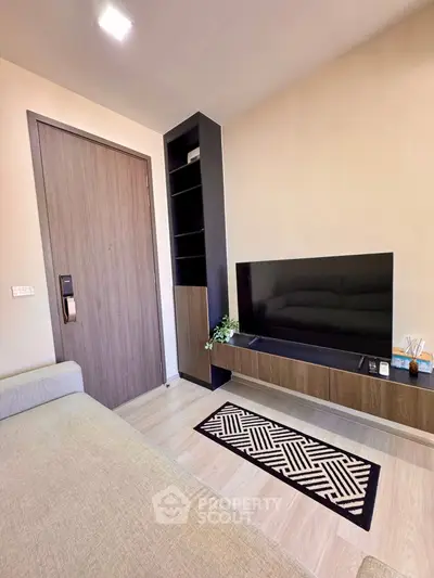 Modern living room with sleek TV unit and cozy seating area