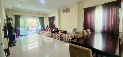 Spacious living room with modern decor and large windows for natural light.