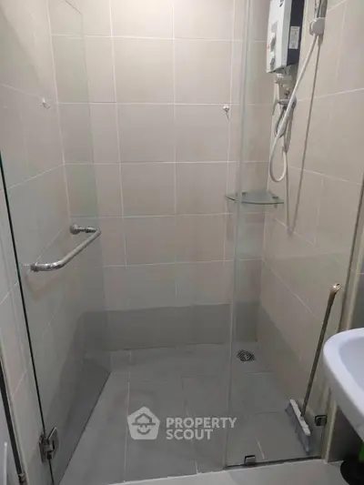 Modern bathroom with glass shower enclosure and water heater