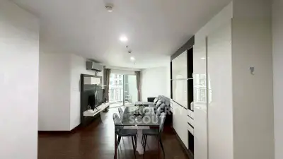 Spacious modern living room with dining area and balcony view