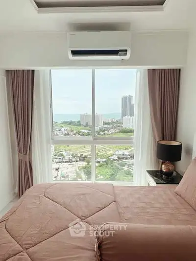 Modern bedroom with stunning city and sea view, featuring elegant decor and natural light.
