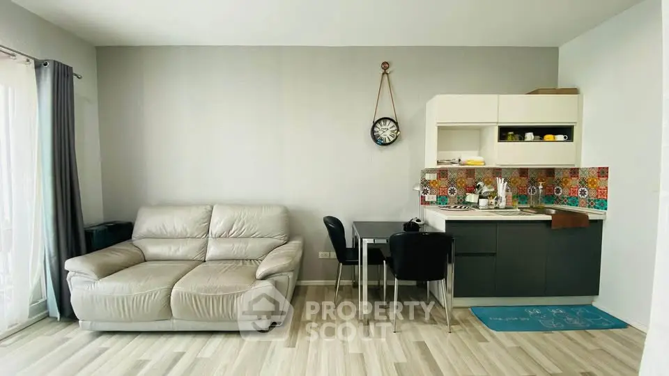 Modern living room with stylish kitchenette and cozy seating area