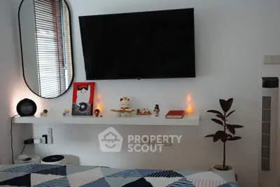 Cozy bedroom with modern decor and wall-mounted TV
