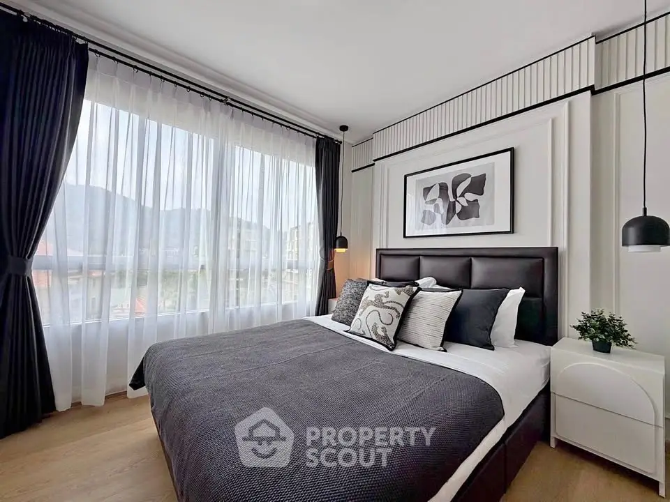 Modern bedroom with large window and stylish decor