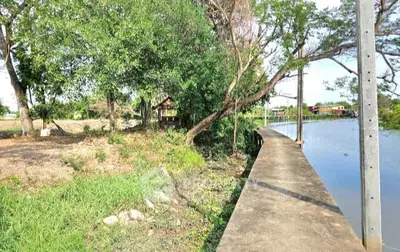 Scenic riverside property with lush greenery and tranquil water views, perfect for nature lovers and serene living.