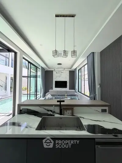 Luxurious modern living room with pool view and elegant interior design