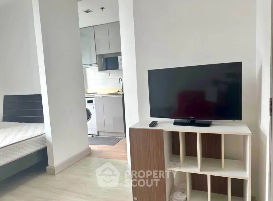 Modern studio apartment with open layout, featuring a cozy bedroom, sleek kitchen, and stylish living area.