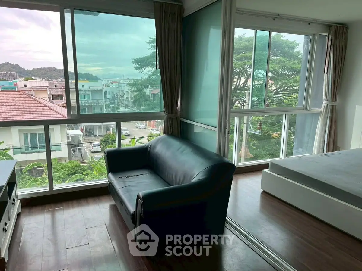 Spacious corner unit with large windows offering a great view, featuring a cozy living area and bedroom.