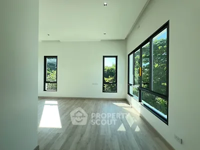 Spacious and bright room with large windows and scenic views, perfect for modern living.