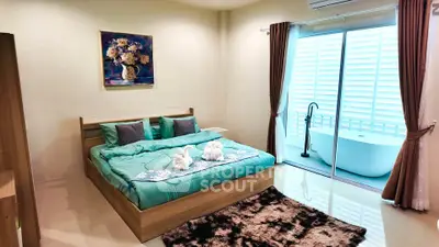 Luxurious bedroom with elegant decor and private balcony featuring a stylish bathtub.
