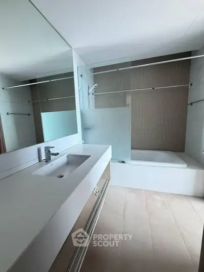 Modern bathroom with sleek design and spacious bathtub in a contemporary apartment.