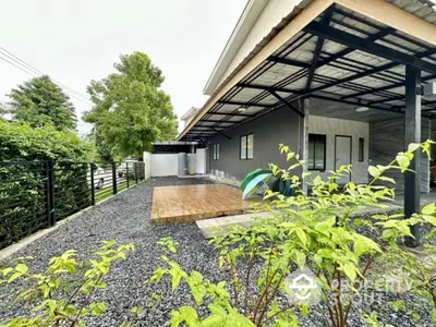 Spacious backyard with modern patio and lush greenery, perfect for outdoor relaxation.