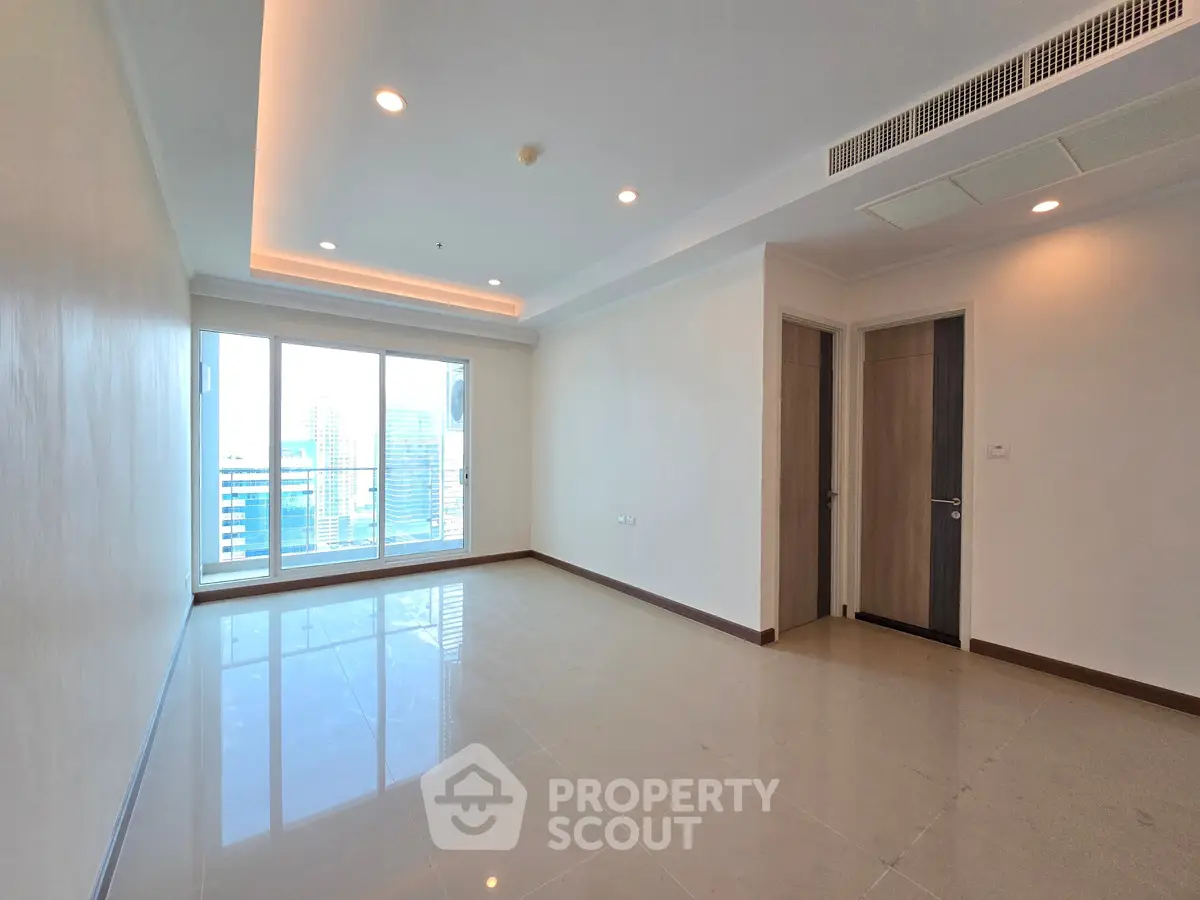 Spacious modern living room with large windows and city view