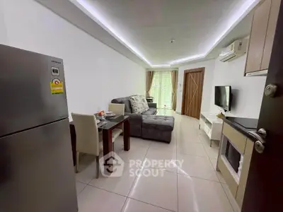 Modern living room with sleek furniture and open layout, featuring a cozy sofa and dining area.