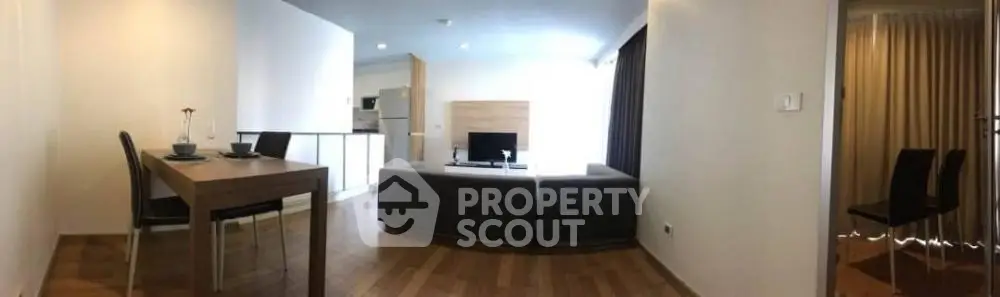Spacious living room with modern furniture, sleek hardwood floors, and abundant natural light, perfect for entertaining and relaxation.