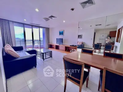 Spacious living room with balcony view, modern furniture, and ample natural light.