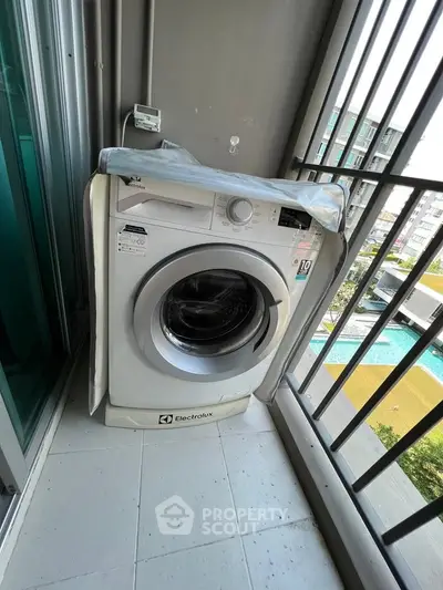 Modern balcony with washing machine overlooking pool and garden view