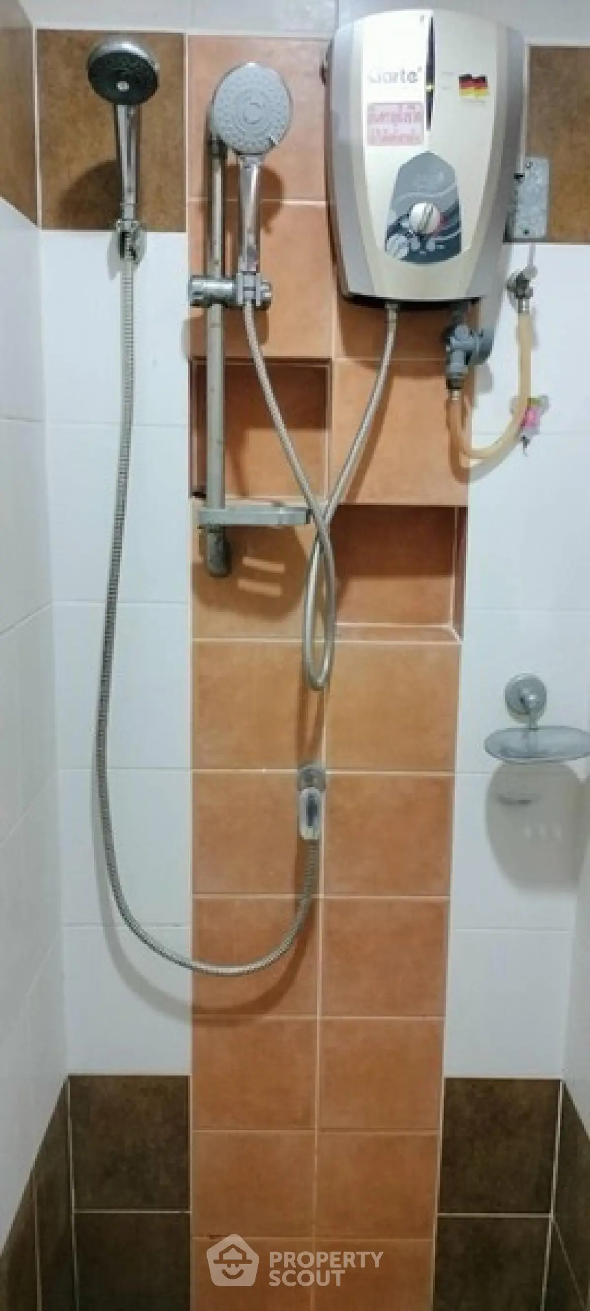 Modern bathroom shower with water heater and tiled walls