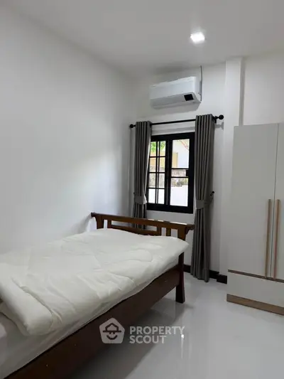 Cozy bedroom with modern air conditioning and natural light
