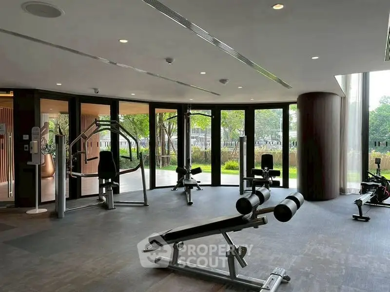 Spacious modern gym with state-of-the-art equipment and garden view.