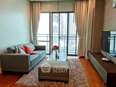 Stylish living room with modern decor and large windows offering city views.