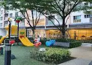 Charming residential playground with modern equipment and lush greenery.